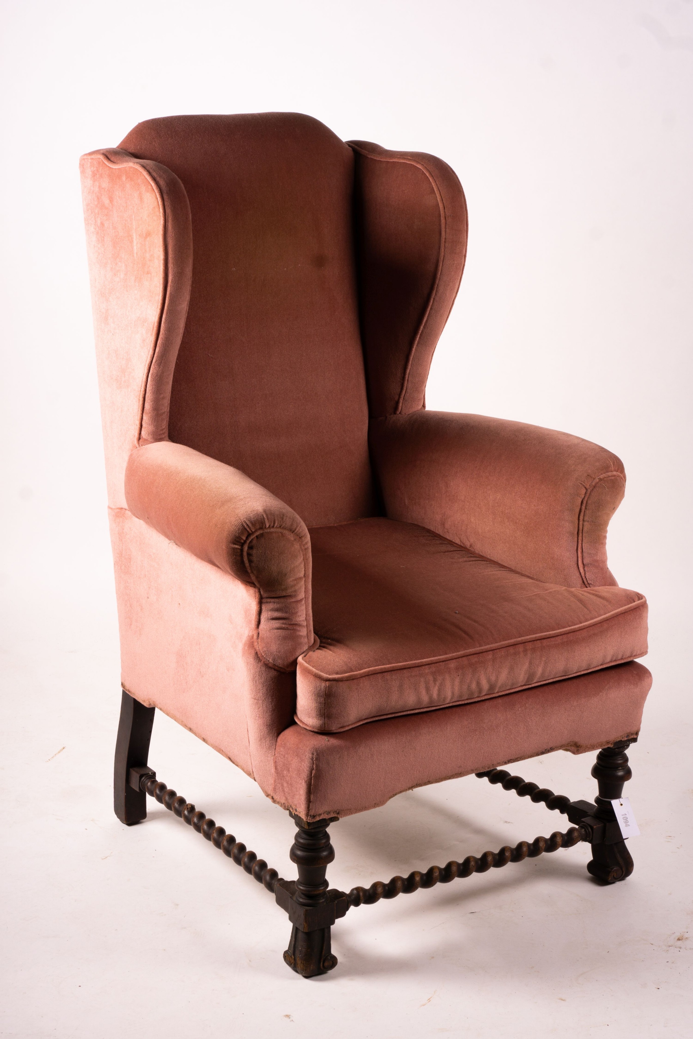 An early 20th century Jacobean revival upholstered wing armchair, width 84cm, depth 90cm, height 128cm